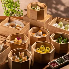 A tower of bamboo steamers filled with different types of dim sum. This shot creates a sense of excitement and variety, making you want to lift every lid.