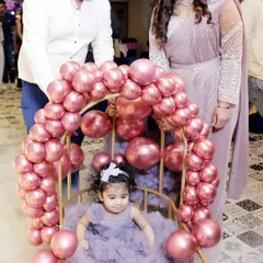 The birthday girl makes her entrance in a special chair decorated with pink balloons. Capturing these unique, planned moments is a key part of my event photography service.