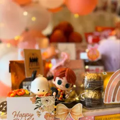 A close-up of the personalized 'Happy Birthday Tanishka' card, surrounded by whimsical figurines and treats. Every detail is designed to make a young girl's birthday feel truly magical.