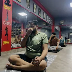 A group of students practicing pranayama together. These breathing exercises are simple to learn and can be practiced at a desk for instant stress relief.