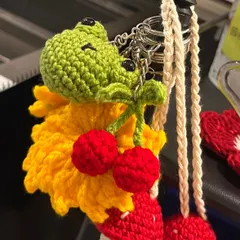 A close-up of some of my recent orders, including this adorable frog charm with little cherries. I love combining different elements to make something truly unique.