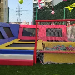 This is our modular Trampoline Park, available for rent. It features multiple jumping surfaces and an attached foam pit, all enclosed with safety netting and soft padding, making it suitable for kids' parties and community events.