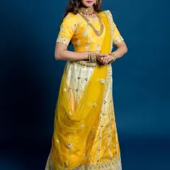 A full-length view of our bright yellow lehenga with delicate mirror work, styled for a traditional event. This outfit is a popular rental choice for haldi ceremonies or daytime wedding functions.