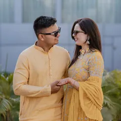 A sweet portrait of the couple during their Haldi ceremony, dressed in matching yellow outfits and sharing a happy, relaxed moment together.