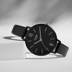 A classic black Sonata watch styled in a high-contrast black and white setting. The sharp lines of the props and the dramatic lighting give this shot a sophisticated and timeless feel.