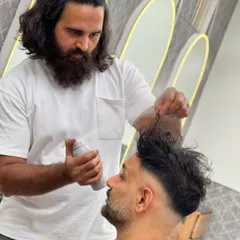 Here I am adding the finishing touches with some styling spray to hold this textured skin fade in place. This technique adds volume and ensures the look lasts all day.