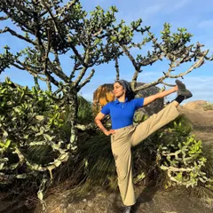 A standing leg extension pose amidst the unique trees on the Uttari Betta trail. Yoga isn't just for the mat; it's about finding moments of mindful movement wherever you are.