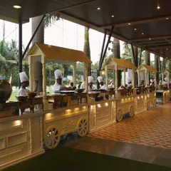 The counter display setup for our Food Festival 2024. A long line of our signature white food carts, staffed by chefs and ready for a big crowd.