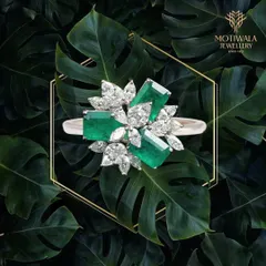 Nature's beauty is captured in this striking ring, where vibrant emeralds are juxtaposed with marquise and pear-shaped diamonds. It is a piece of wearable art for the discerning collector.