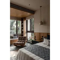 This view highlights the comfortable reading chair and the connection to the window seat. We aimed to create different zones within the room for various activities.