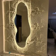 A unique dressing mirror design. We created this organic, free-form mirror by cutting it out of a textured stone panel and adding backlighting for a dramatic effect.