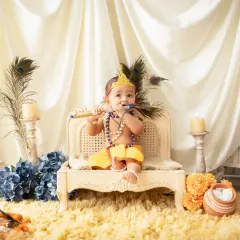 A sweet baby dressed as Lord Krishna, playing a flute. These themed shoots are a wonderful way to celebrate cultural traditions and create lasting memories.