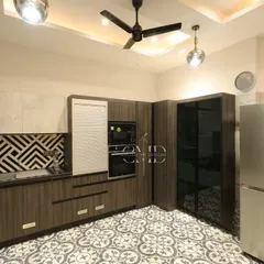 The kitchen includes an integrated unit for the oven and microwave, with a sleek black-and-white patterned backsplash adding a modern touch.
