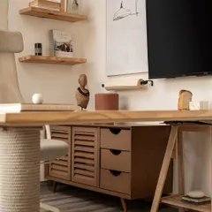 A detail of one of the workstations in our studio. We used a combination of natural wood tones, including a slatted credenza and open shelving, to bring warmth and texture to the space, ensuring even functional areas feel thoughtfully designed.