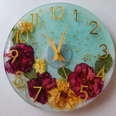 This floral preservation clock was a true labor of love, taking a week to complete. I embedded a client's treasured flowers against a soft blue background with gold accents, creating a functional piece of art that is completely unique to them.
