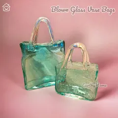 A truly unique piece, our blown glass handbag vase is a work of art. Use it to hold a small bouquet or as a standalone sculpture to wow your guests.