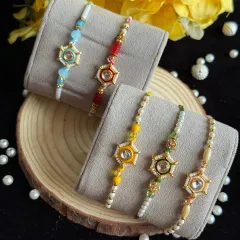 Modern star-shaped rakhis with a central stone. Available in multiple colors like red, blue, and yellow, these are perfect for a brother with a contemporary style.