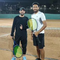 We welcome players of all levels. Here, our head coach is with DJ NYK, who is enjoying his tennis journey with us. It's never too late to start playing or to take your game to the next level.