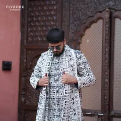A closer look at the bold, modern aesthetic of this black and white geometric print sherwani jacket. It's a statement piece for any man wanting a contemporary ethnic look.