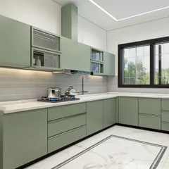 This kitchen showcases a fresh, modern aesthetic with sage green cabinetry and a white subway tile backsplash. The design includes a mix of solid and glass-front upper cabinets, a built-in chimney, and under-cabinet lighting for a bright and practical workspace.