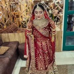 Another angle of our stunning bride, showcasing the full effect of her makeup, heavy jewelry, and the way we expertly set the dupatta to frame her face beautifully.