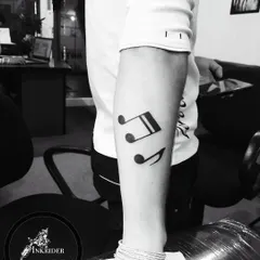 A set of musical notes on the forearm. A simple and elegant tattoo for any music lover.