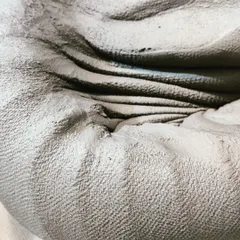 A close-up look at spiral kneading, an essential first step to prepare stoneware clay. This process removes air bubbles and creates a uniform consistency, ensuring the clay is ready for the wheel.