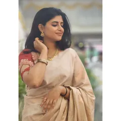 Dressed in a beautiful cream and red saree. I love embracing traditional wear for special occasions.