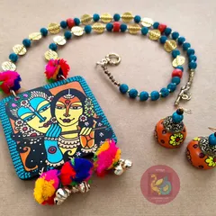 A closer look at the vibrant Radha Krishna necklace set. This angle shows the texture of the acrylic beads and the playful movement of the colourful pompoms and brass ghungroos.