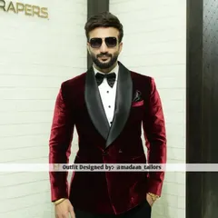 The epitome of classic luxury. Our client wears a bespoke double-breasted tuxedo crafted from rich maroon velvet with a contrasting black satin shawl lapel, perfect for any black-tie affair or cocktail evening.
