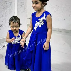Twinning isn't just for mothers and daughters. I designed these matching royal blue georgette gowns for two sisters, complete with delicate white appliqué for a touch of elegance.
