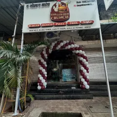 A clear, straight-on view of the maroon and white balloon arch, showcasing how it enhances the storefront for a business launch.