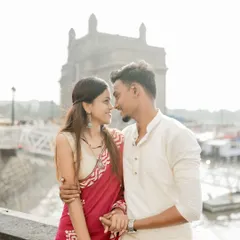An intimate couple portrait captured at the Gateway of India, with the bride in a beautiful red saree and the groom in a classic white kurta. This image celebrates love rooted in Maharashtrian tradition against a landmark Mumbai backdrop.