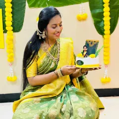 The beautiful bride-to-be holding her custom Kelvan cake. We are so happy she loved how the topper matched her saree.