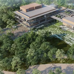An aerial rendering of the Mahindra University project, showing its integration within a dense green landscape. The design respects the existing topography and uses it to create a multi-level program of activities.