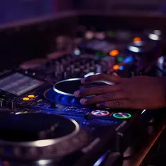 Getting hands-on with a Pioneer CDJ. In my studio, you'll learn scratching and mixing techniques on the same professional equipment used in top clubs worldwide, ensuring you're prepared for real gigs.