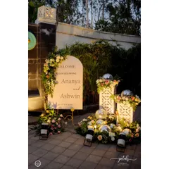 A glamorous welcome to a Sangeet night. The arched sign is flanked by floral arrangements and disco balls, immediately signaling a night of fun and celebration.