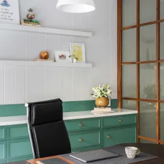A well-designed workspace inspires productivity and calm. This executive cabin, with its clean lines, soothing green cabinetry, and warm wood partitions, demonstrates our approach to creating functional yet aesthetically pleasing office interiors.