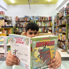 This is the ultimate goal: a child completely lost in the world of a book. In our library, we create a cozy and encouraging environment where children can explore thousands of titles and find stories that speak directly to them, fostering a lifelong love for reading.
