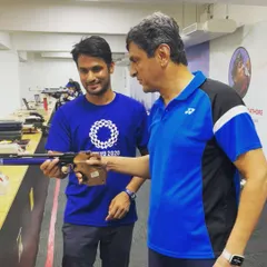 A memorable moment guiding Indian badminton legend Prakash Padukone as he tries pistol shooting for the first time.
