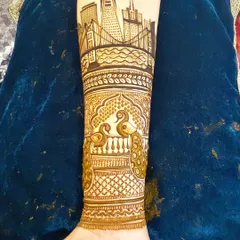 The completed San Francisco skyline design, now integrated into a full bridal arm piece with traditional peacock and jali (net) patterns below it.