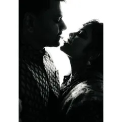 A high-contrast, silhouette-style black and white portrait. This artistic shot focuses on the couple's profiles and the space between them, creating a dramatic and intimate mood.