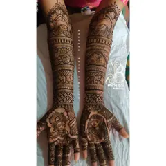For a touch of divine love, I often create Radha-Krishna portraits. This design combines the classic spiritual motif with intricate patterns and traditional elements like elephants, covering the full arm for a complete bridal look.