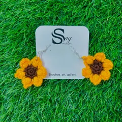A clear product shot of the crochet sunflower earrings against my brand card. They make a wonderful and unique handmade gift.