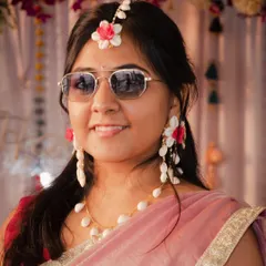 A close up portrait that highlights the bride's fun personality. The combination of traditional floral jewelry and modern aviator sunglasses makes for a memorable and stylish shot.