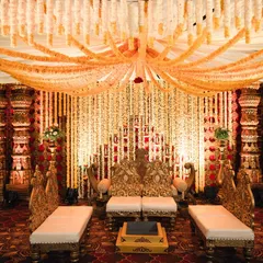 A magnificent wedding stage inspired by traditional South Indian temple design, featuring rich colors, intricate pillars, and beautiful floral arrangements.