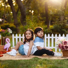 The bond between siblings is so special. We captured this beautiful, candid moment during an outdoor picnic-themed session, filled with sunshine and laughter.
