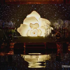 A giant, illuminated rose sculpture served as the stage backdrop for this elegant reception. My team fabricates these unique, large-scale art pieces in-house to serve as stunning focal points.
