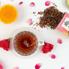 A top-down flat lay is a powerful format for social media and websites. Here, we arranged a brand's rose and lemon tea with its core ingredients and packaging, creating a visually clean and informative shot that tells a story of flavor and quality.