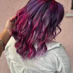Bringing the light with this purple and pink beauty. This is a full transformation with a fresh cut and a vibrant color melt, using bleach to get these bright, beautiful shades.